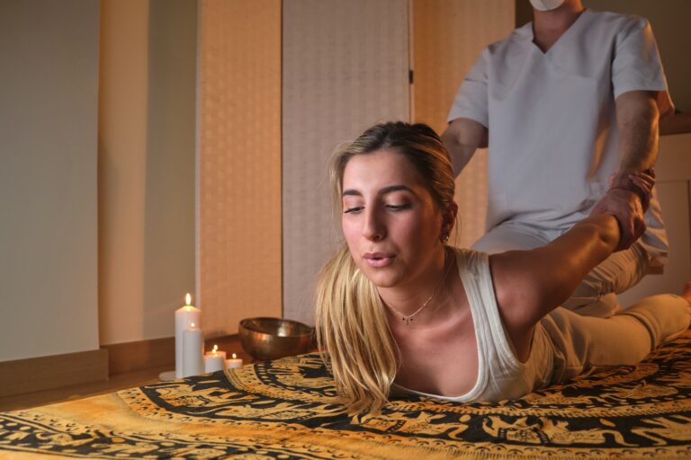 woman enjoys a thai massage by candlelight